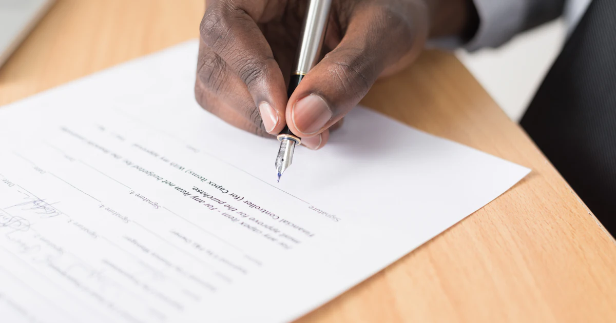 person writing on white paper